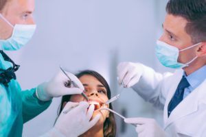 dentists-working-with-young-female-patient-7H3PK62