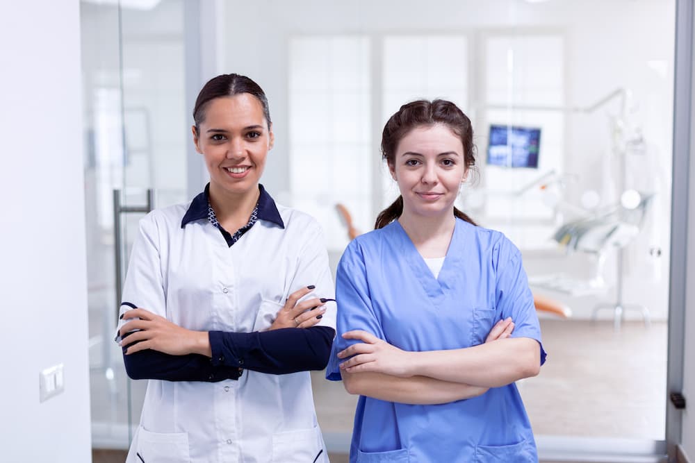 portrait-of-smiling-dentist-and-nurse-smiling-7M2C4CQ (1)